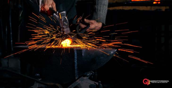 blacksmith manually forging molten metal