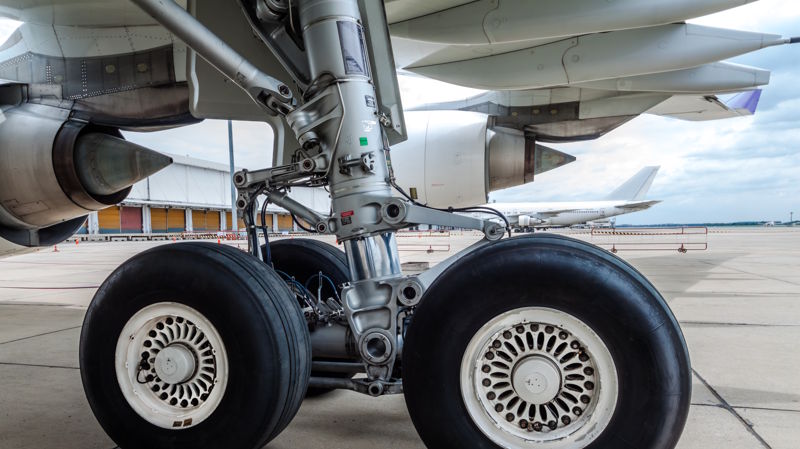 close up of airplane wheel parked at the airport close up of airplane wheel parked at the airport