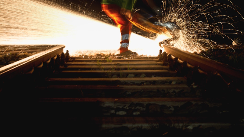 man working with steel on railway man working with steel on railway