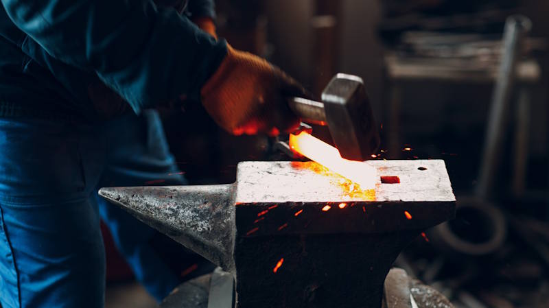 hot metal shaping with hammer and anvil